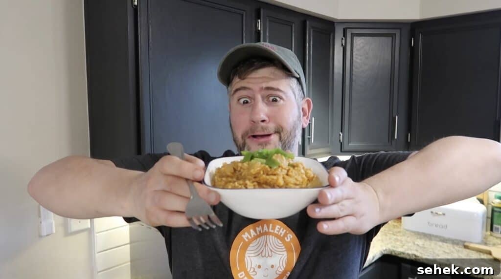 Instant Pot Nashville Hot Chicken with Spiced Rice 21 Man holding bowl of Nashville Hot Chicken & Rice