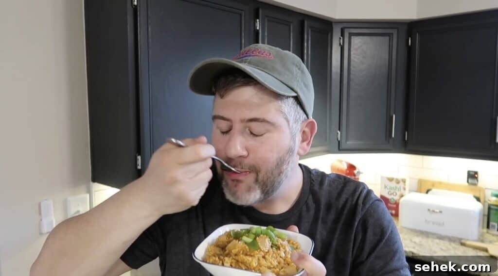 Instant Pot Nashville Hot Chicken with Spiced Rice 22 Man eating a forkful of the food