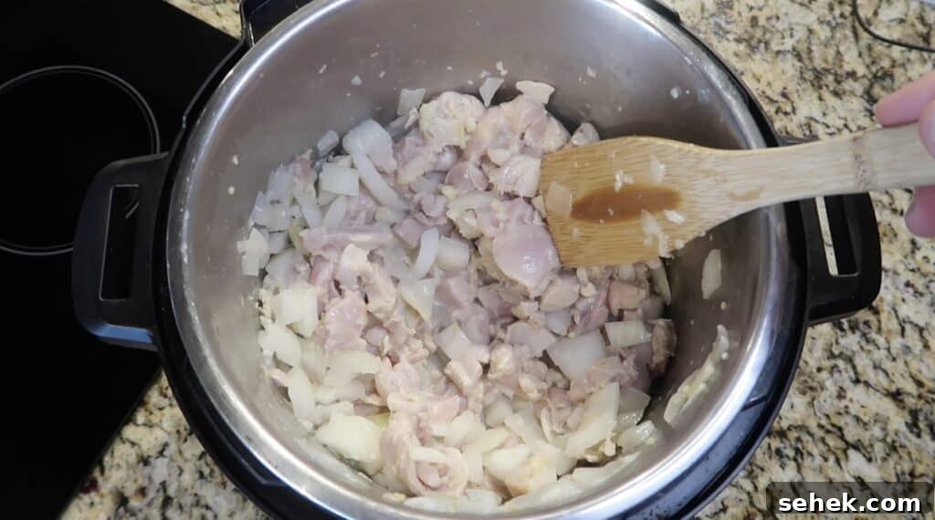 Instant Pot Nashville Hot Chicken with Spiced Rice 9 Sautéing chicken until it's pinkish-white in color.