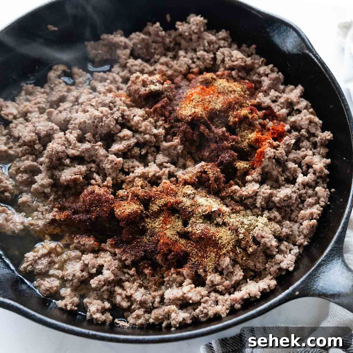 Weeknight Gluten-Free Tacos That Transform Dinner 6 taco meat with seasonings sprinkled over the top.
