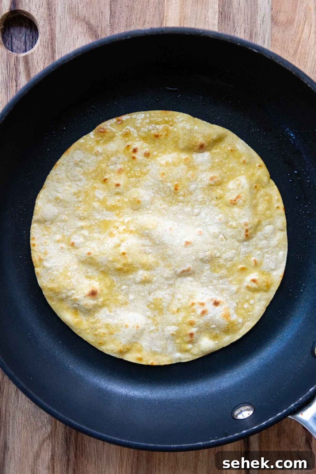 Weeknight Gluten-Free Tacos That Transform Dinner 7 a corn tortilla in a frying pan.