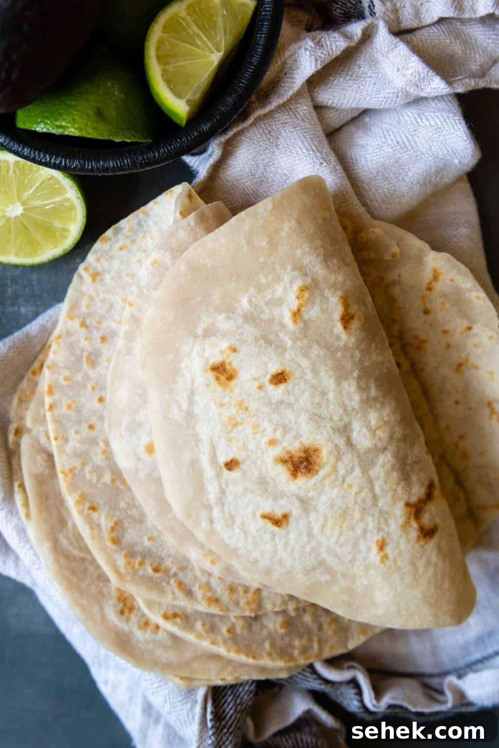 Weeknight Gluten-Free Tacos That Transform Dinner 8 folded over tortillas with a lime nearby.