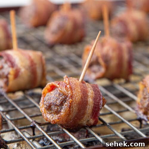 bacon wrapped meatballs on a wire rack.