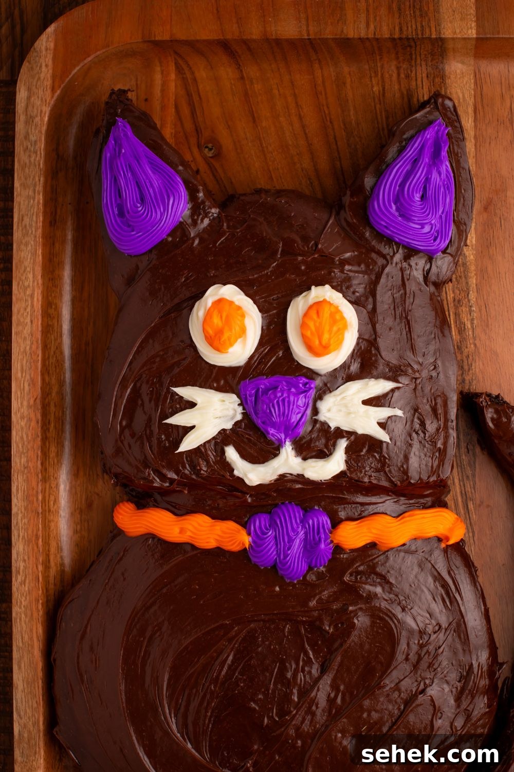 close up of Halloween cat cake on a wooden tray 