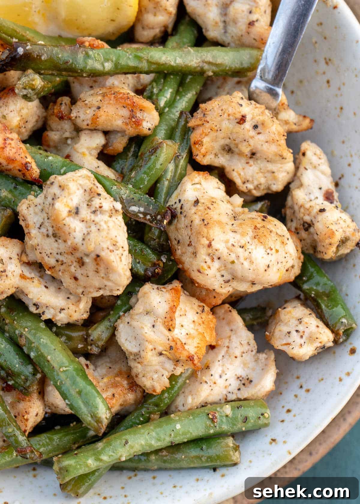 Crispy Lemon Pepper Chicken in the Air Fryer 11 small bowl of air fryer lemon pepper chicken and veggies