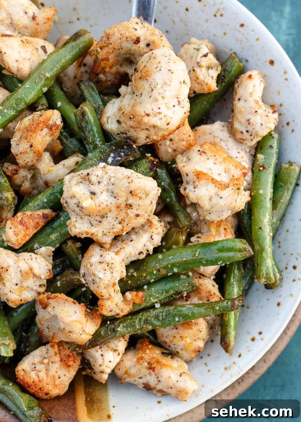 Crispy Lemon Pepper Chicken in the Air Fryer 3 air fryer chicken and green beans covered in lemon pepper seasoning