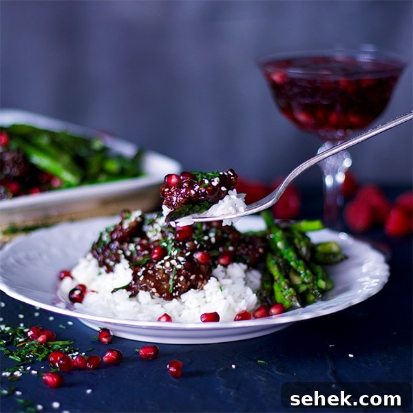 Sesame Chicken with Pomegranate Raspberry Glaze 5 Taking a bite of Pomegranate Raspberry Sesame Chicken