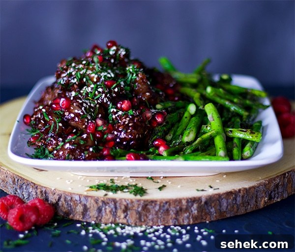 Pomegranate Raspberry Sesame Chicken with rice and asparagus