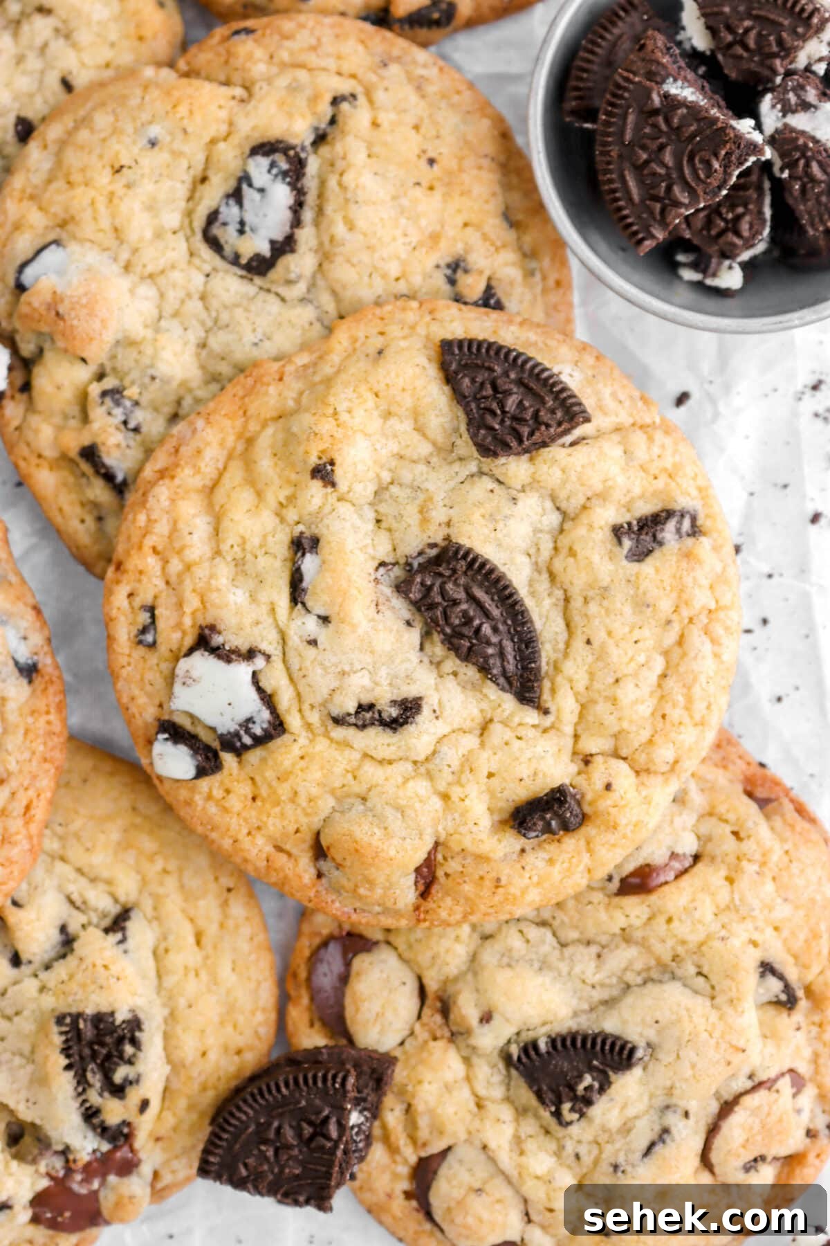 Oreo Chocolate Chip Cookies Recipe — Crispy Cookies with Oreo Chunks 10 overhead close up of oreo chocolate chip cookie piled on top of other cookies.