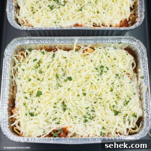 image of aluminum trays that are filled with baked ziti ready for the freezer.
