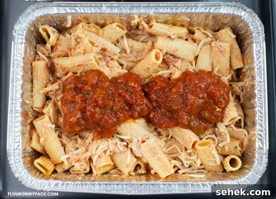 an aluminum tray of baked ziti before freezing