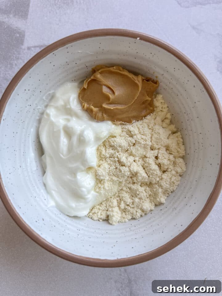 ingredients for 3-ingredient peanut butter yogurt dip in a small bowl 