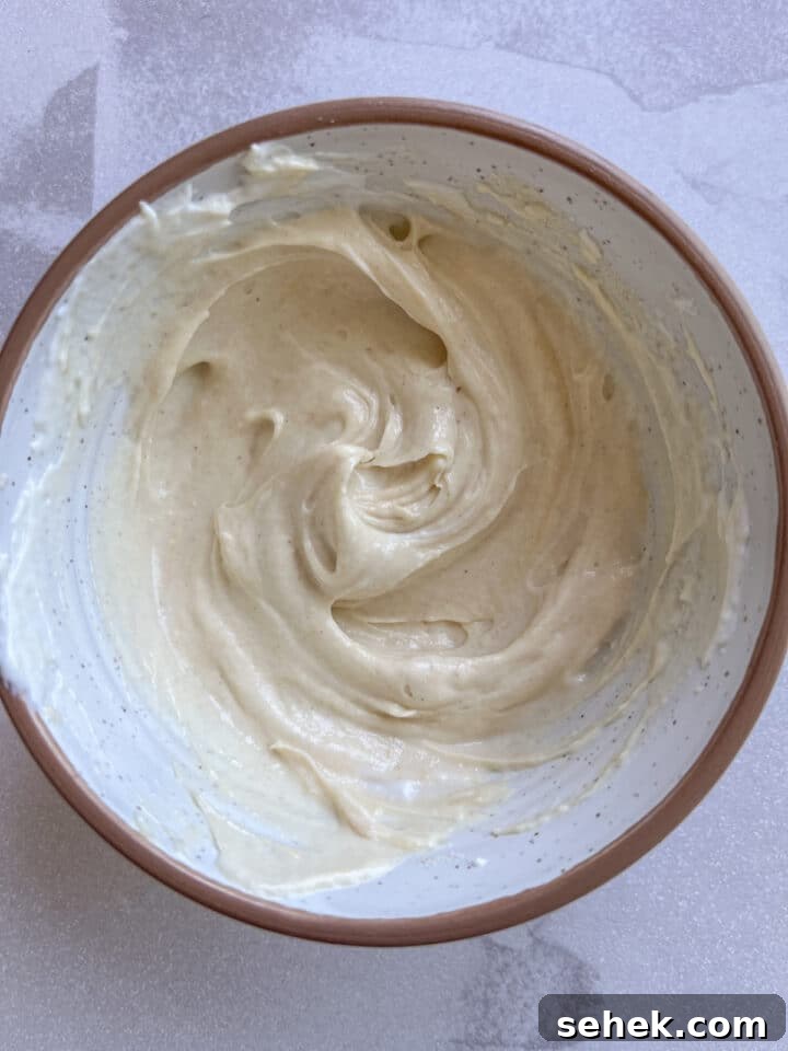 ingredients for 3-ingredient peanut butter yogurt dip with protein powder in a small bowl, mixed