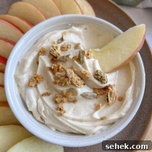 Peanut butter yogurt dip with apple slices on a plate