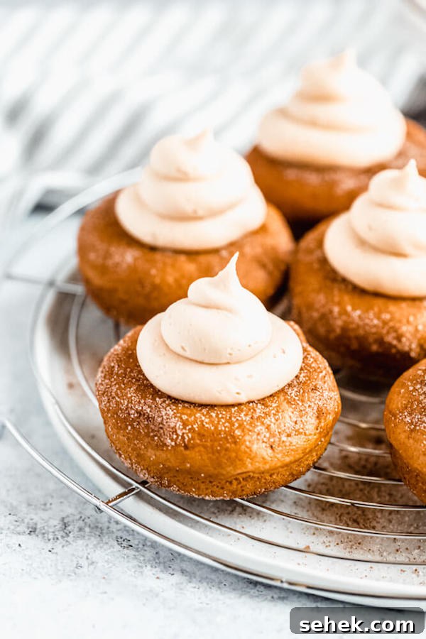 Pumpkin donuts with salted caramel cream cheese frosting pumpkin donuts topped with salted caramel cream cheese frosting on a round wire rack
