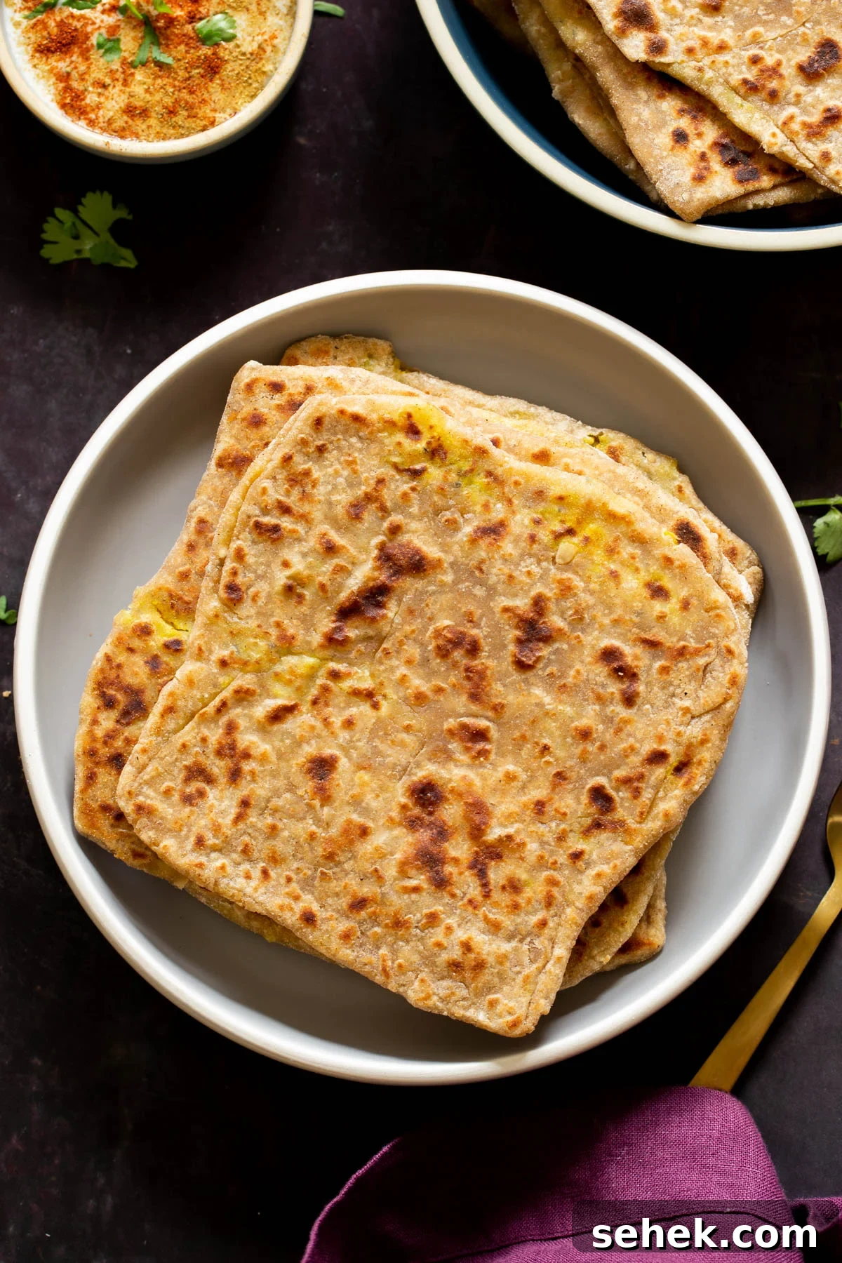aloo paratha pilled up on a plate