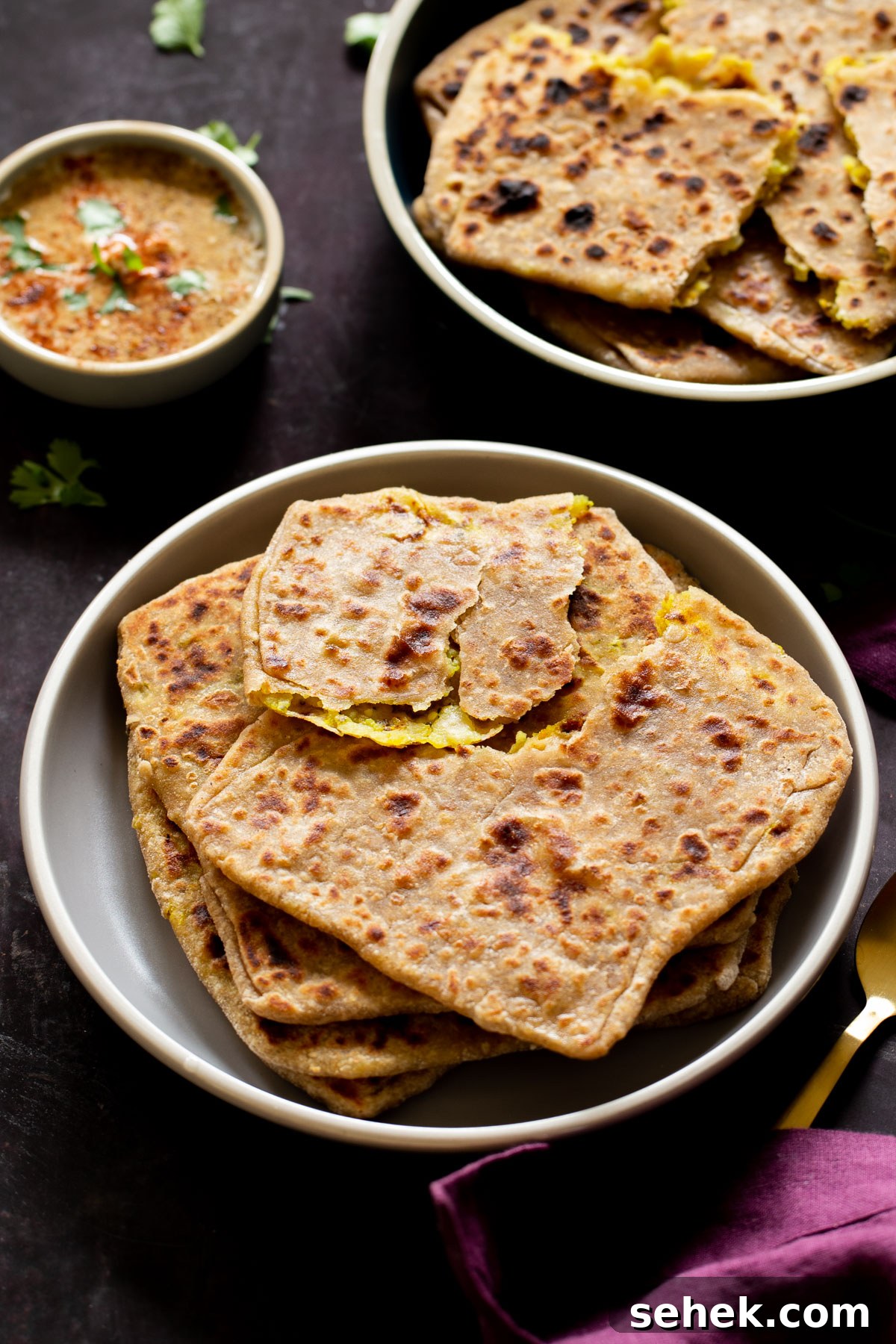 serving platters of aloo paratha with chutney for dipping