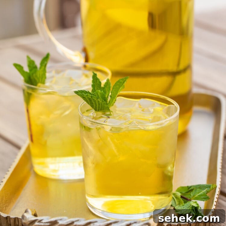 How to Make Refreshing Cold Brew Green Tea at Home 5 Two glasses of cold brew green tea in front of a pitcher on a table.