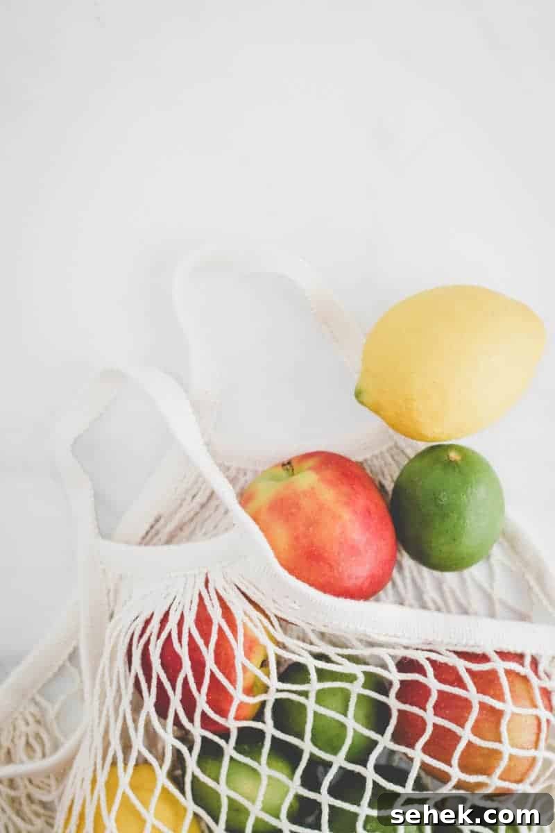 10 Budget-Friendly Gluten-Free Tips to Save Money 9 Ikea KUNGSFORS mesh produce bag with apples, lemons, and limes spilling out.