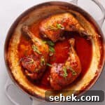 Chicken leg quarters smothered in a spicy ginger, citrus and soy sauce in a large skillet.