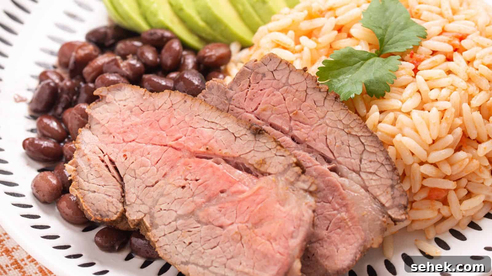 Slices of baked carne asada on small wood cutting board.