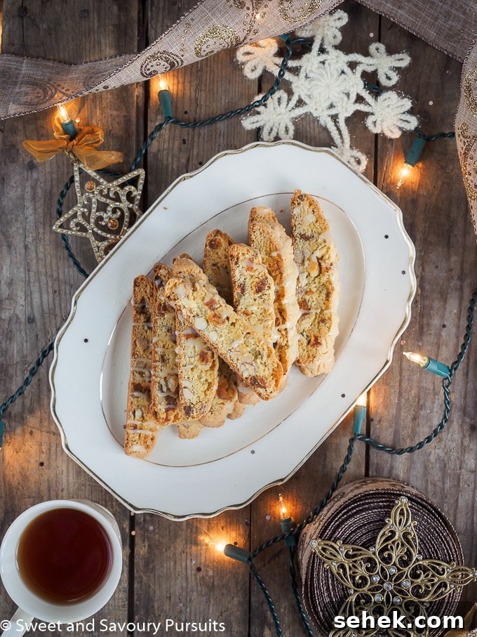 Apricot Almond Biscotti with White Chocolate Drizzle 2 Apricot and Almond Biscotti with White Chocolate Drizzle on serving plate.