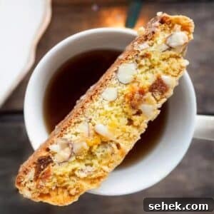 Apricot Almond Biscotti with White Chocolate Drizzle 5 Apricot and almond biscotti on top of cup of tea.