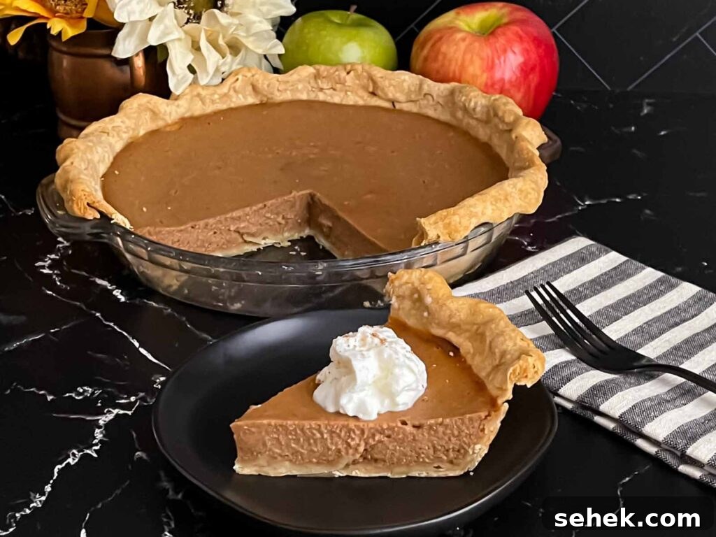 Irresistible Apple Butter Pie Recipe for Fall Baking 2 Apple butter pie with a sliced on a dark plate, garnished with whipped cream.