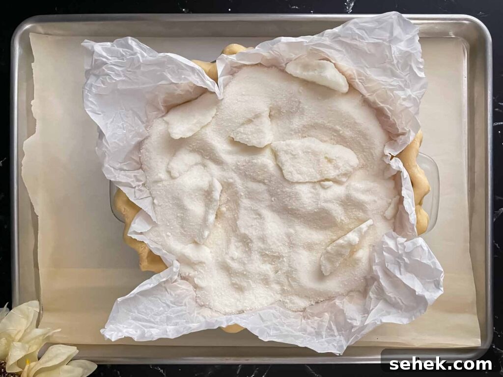 Irresistible Apple Butter Pie Recipe for Fall Baking 4 Homemade pie shell with a sugar weight in it for baking.