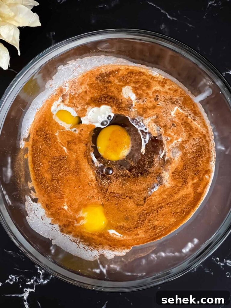 Irresistible Apple Butter Pie Recipe for Fall Baking 5 Apple butter pie mixture in a glass bowl.