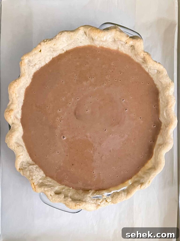 Irresistible Apple Butter Pie Recipe for Fall Baking 8 An apple butter pie, baked and a baking sheet.