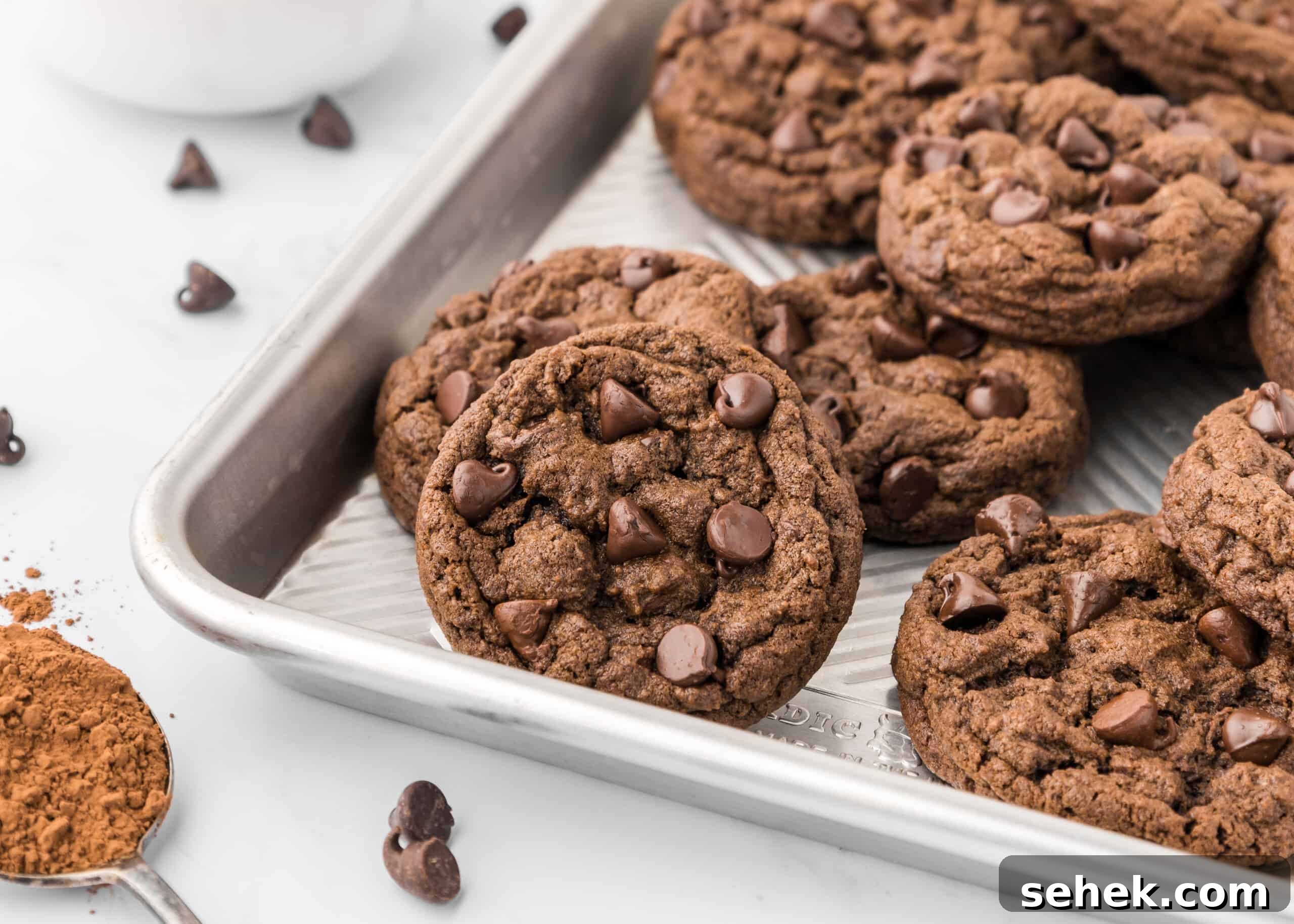 Ultimate Double Chocolate Cookies Recipe for Rich, Fudgy Results 4 Double chocolate chip cookies on a baking sheet.