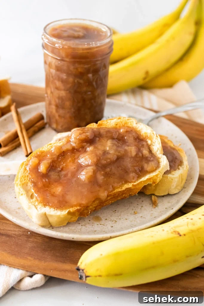 drunken monkey banana rum jam spread on two pieces of toast set on a white plate
