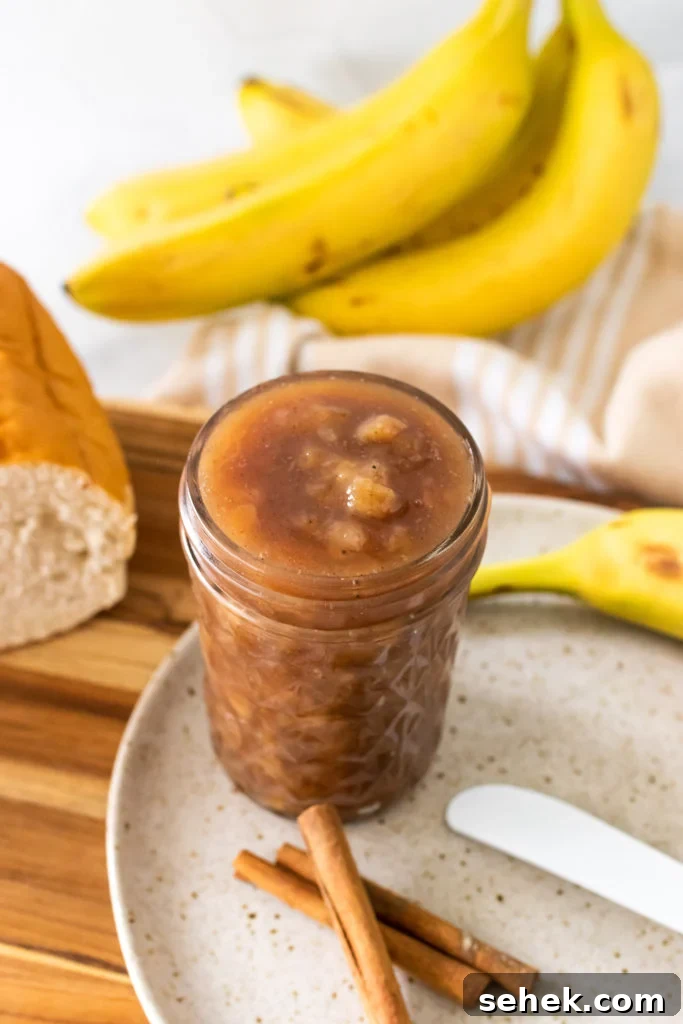 banana rum jam shown in a tall glass jar 