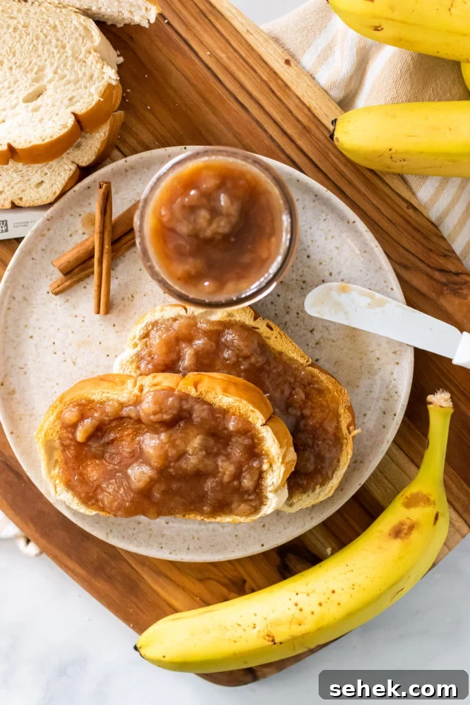 drunken monkey banana rum jam spread on two pieces of toast set on a white plate