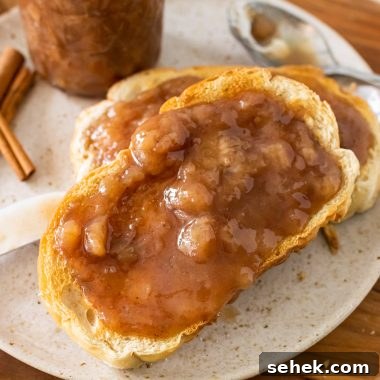 drunken monkey banana rum jam spread on two pieces of toast set on a white plate