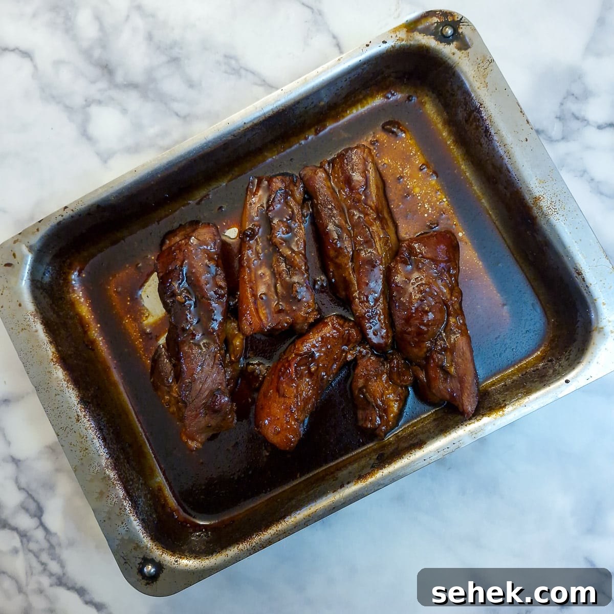Glazed pork belly slices covered in a sticky thickened glaze.