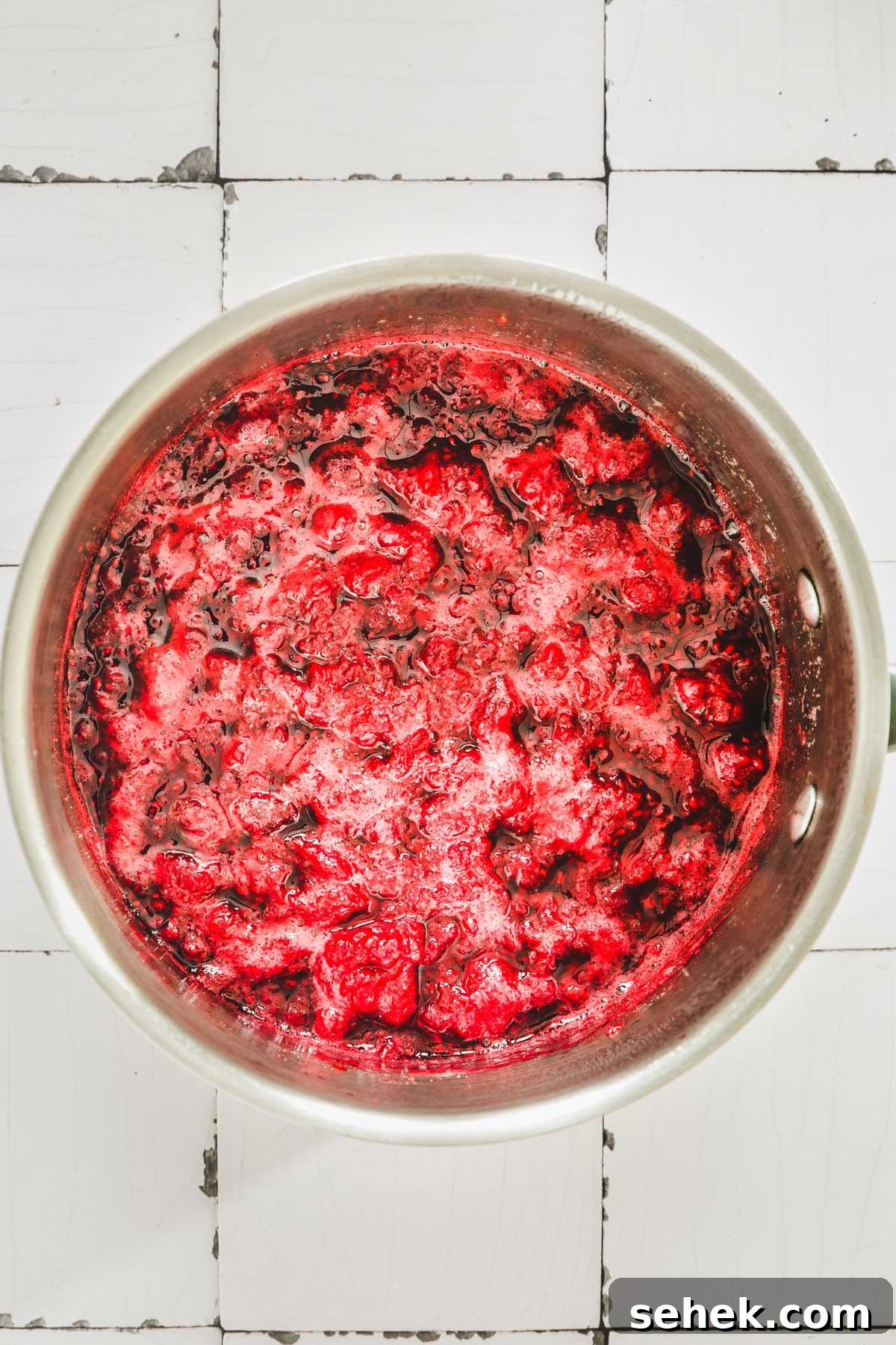 Silky Raspberry Frosting Recipe for Cakes and Cupcakes 4 saucepan cooking raspberry purée