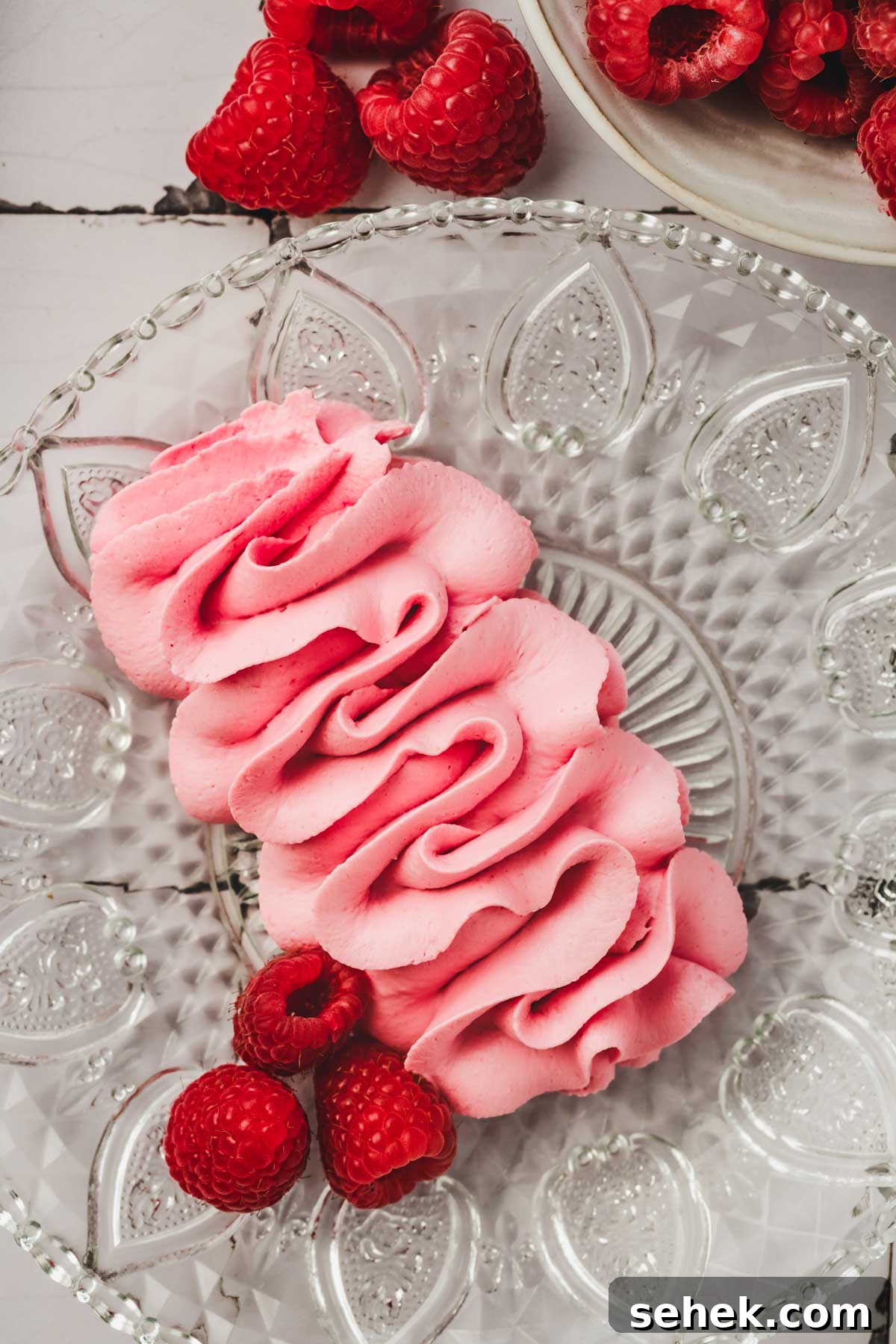 Silky Raspberry Frosting Recipe for Cakes and Cupcakes 7 plate with raspberry frosting