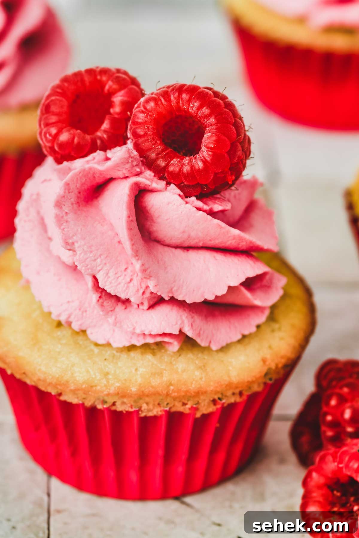 Silky Raspberry Frosting Recipe for Cakes and Cupcakes 8 cupcake with pink raspberry whipped cream frosting