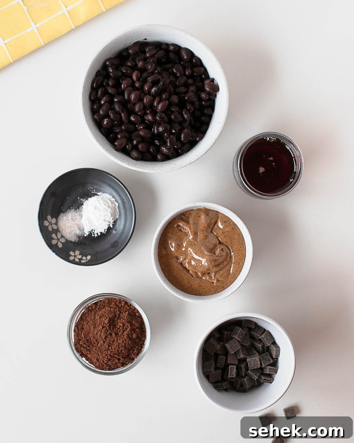 Fudgy Flourless Black Bean Cookies — Vegan Chocolate Treats 4 Ingredients for black bean cookies including black beans, almond butter, cocoa powder, and chocolate chips