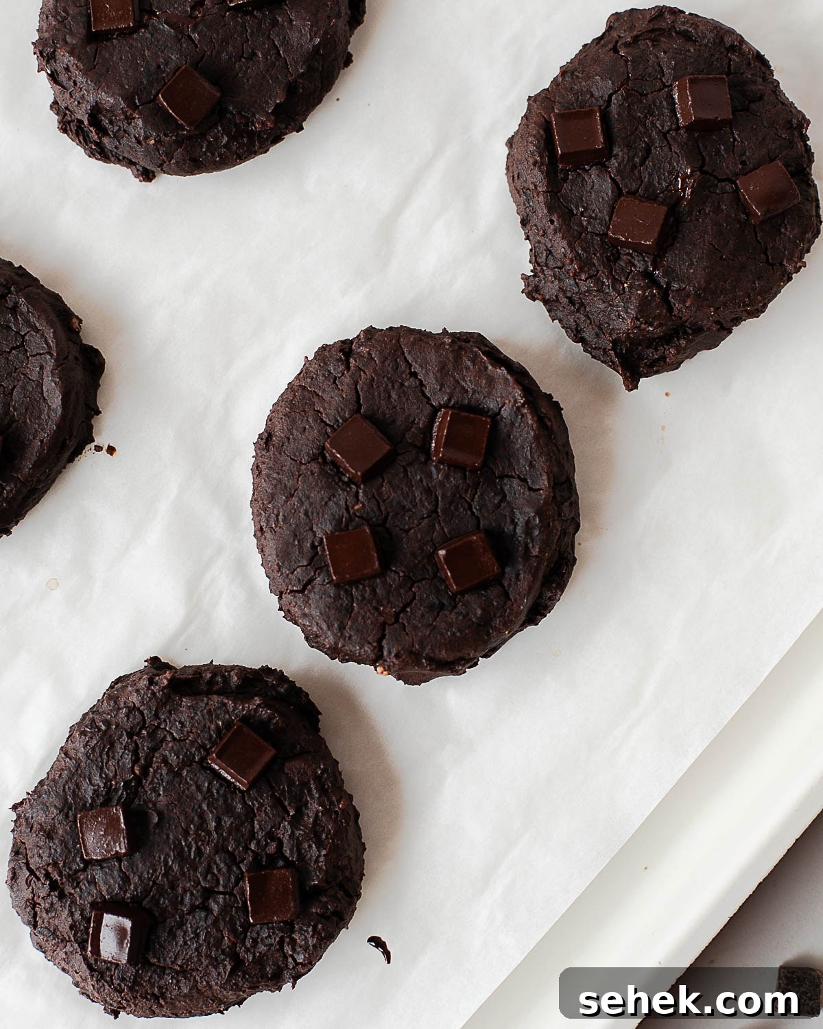 Fudgy Flourless Black Bean Cookies — Vegan Chocolate Treats 5 Close-up of fudgy black bean chocolate cookies with cracked tops and melted chocolate