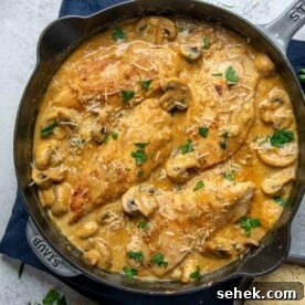 Creamy Dijon Chicken with Mushrooms and Garlic Herbs 11 top view of chicken breast in creamy sauce in a black skillet