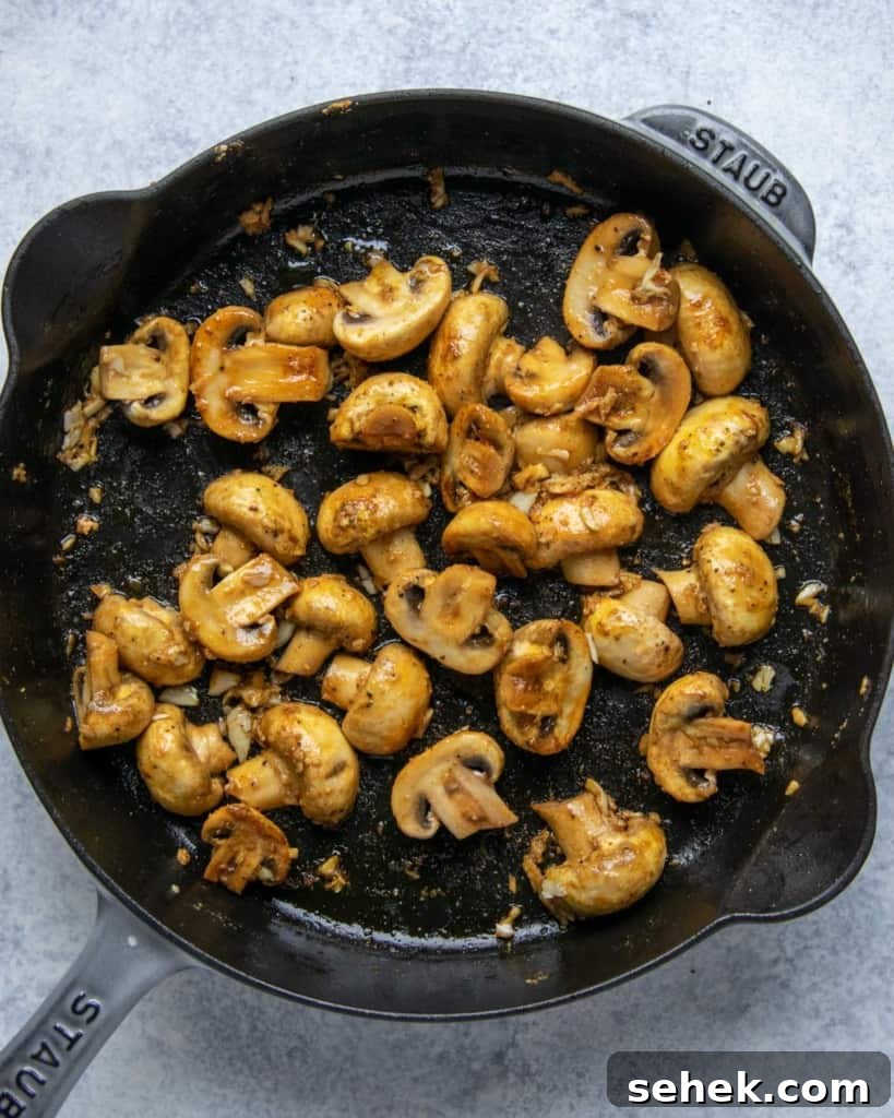 Creamy Dijon Chicken with Mushrooms and Garlic Herbs 7 sauteed mushroom in a black skillet