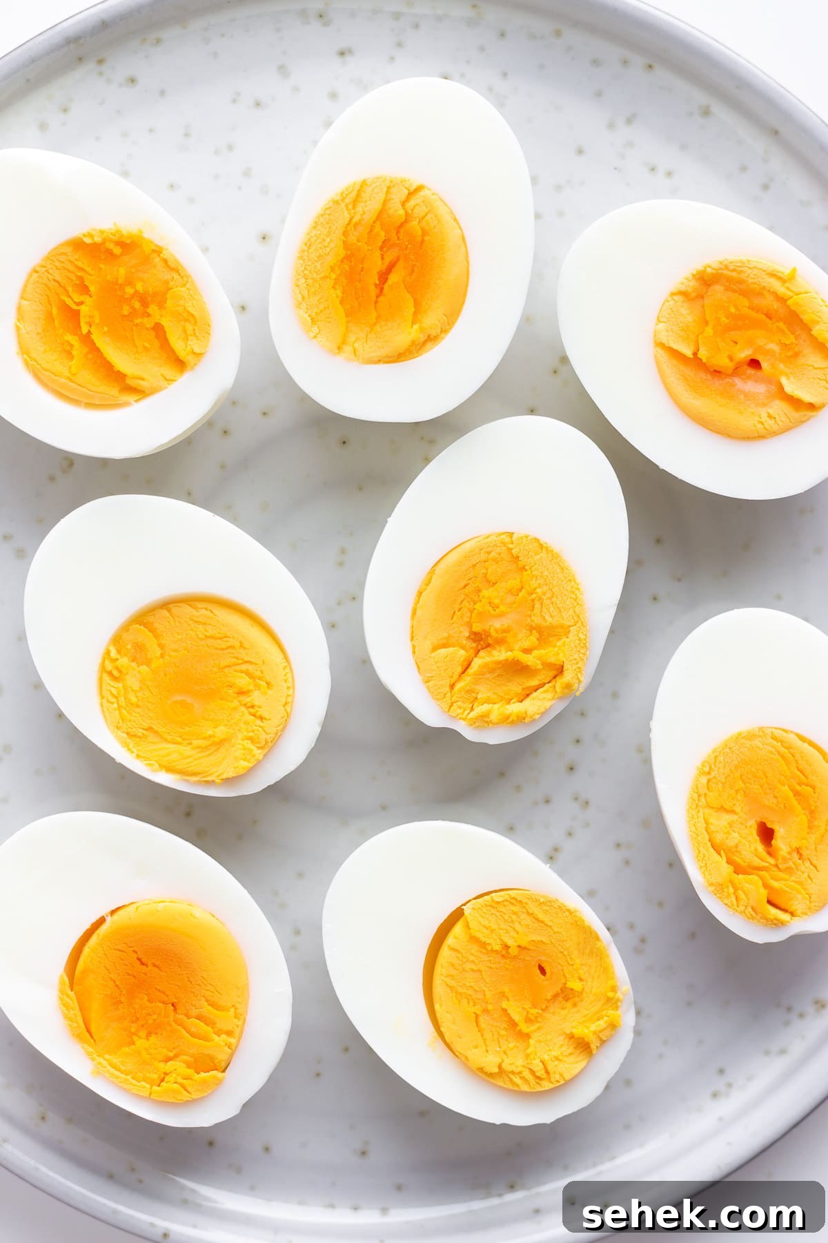 Ways to Use Hard-Boiled Eggs: Recipes, Tips, and Ideas 3 Closeup of halved hard boiled eggs arranged on a plate.