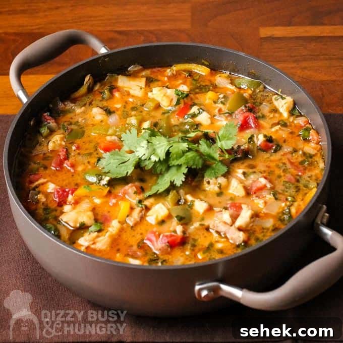 Affordable Seafood Recipes for Flavorful Weeknight Meals 5 Side view of stew in brown pot on a brown placemat.