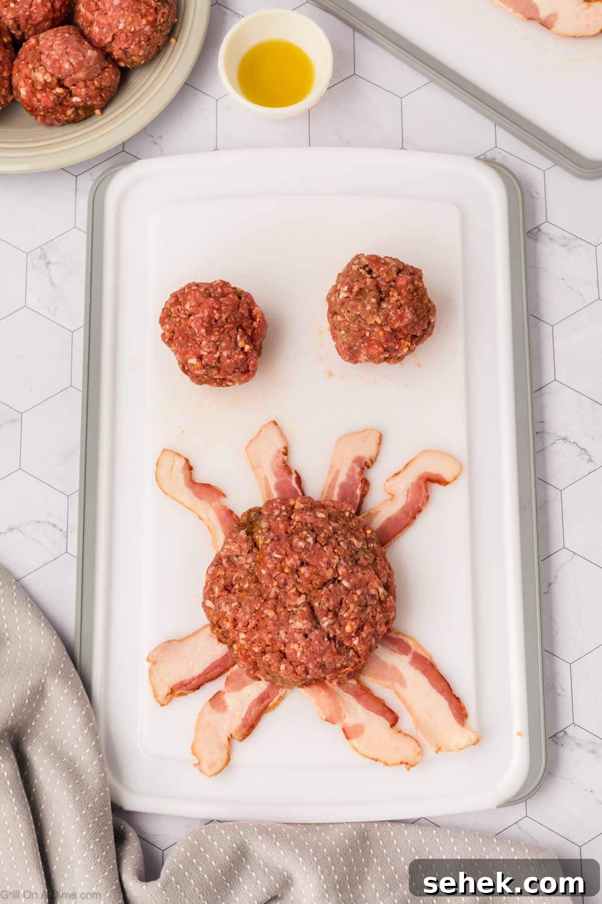 Bacon-Wrapped Burger Recipe: Juicy Grilled Bacon Burger Guide 8 Ground beef pattie on strips of bacon with two ground beef balls on the side