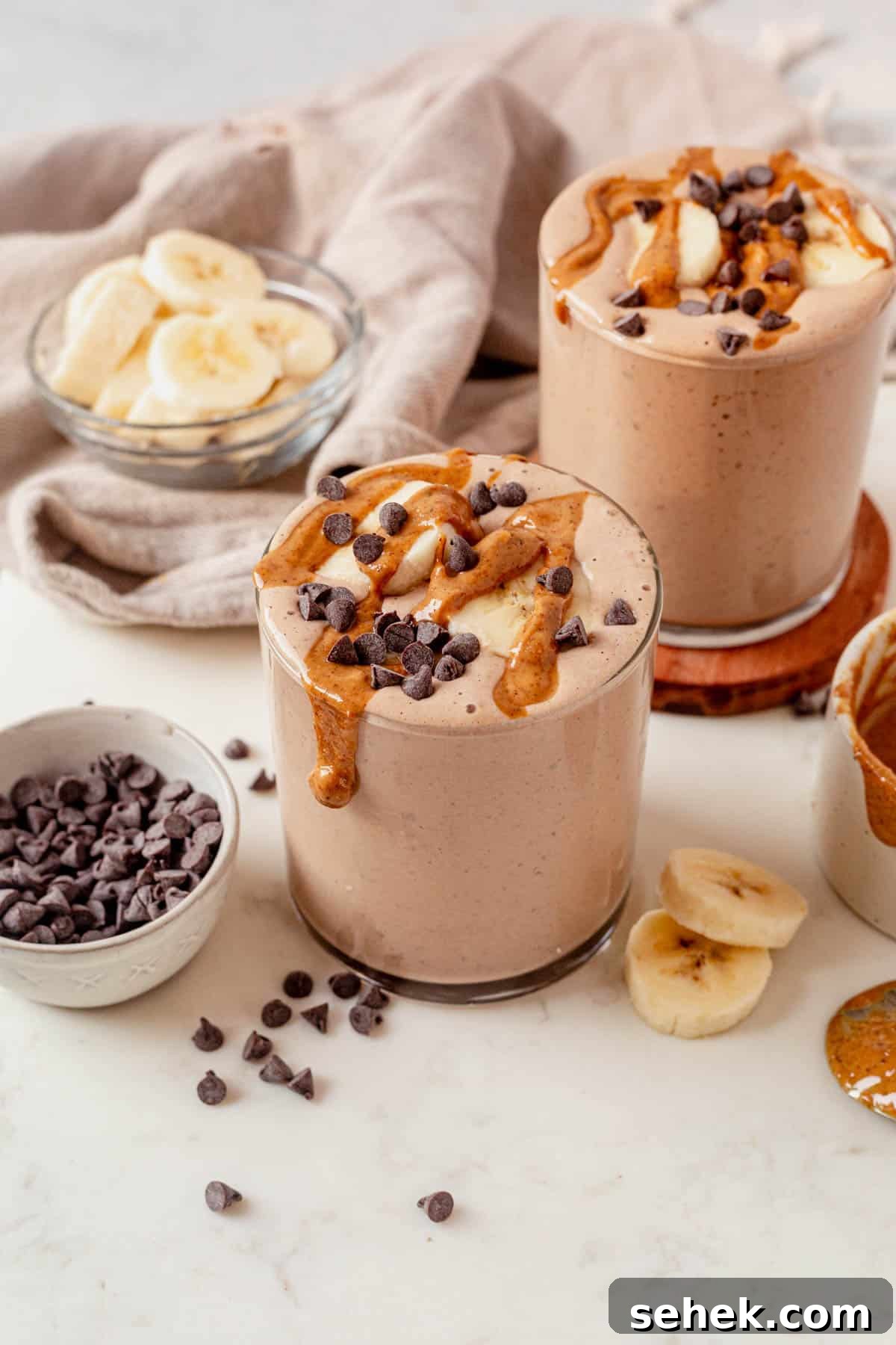 Chocolate Peanut Butter Protein Shake for Muscle Recovery 2 two chocolate peanut butter protein smoothies on a countertop.