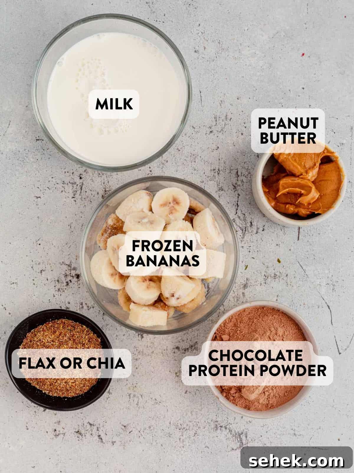 Chocolate Peanut Butter Protein Shake for Muscle Recovery 3 ingredients for a chocolate peanut butter smoothie on a countertop.