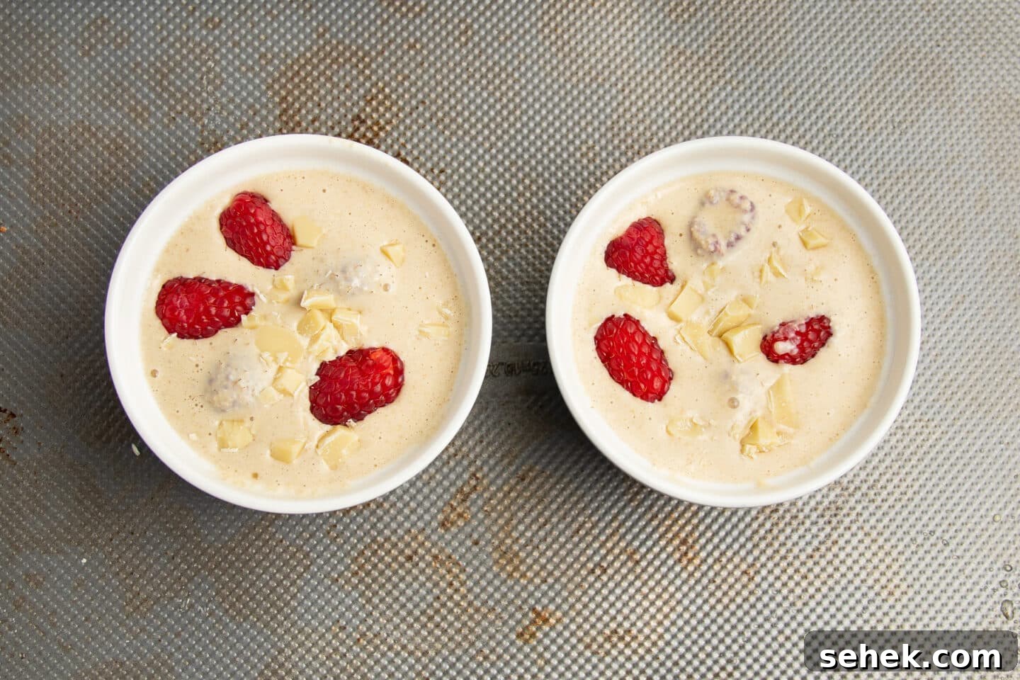 White Chocolate Raspberry Protein Baked Oats 9 This is a picture of the ramekins filled with with baked oats before baking.